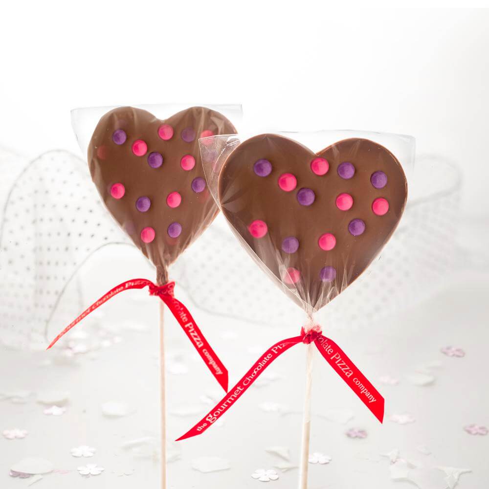 Our beautifully presented Heart Lollipops feature pink and purple chocolate drops.